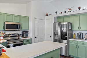 Kitchen featuring green cabinetry and stainless steel appliances