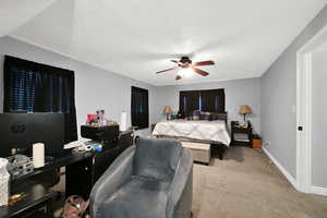 Carpeted bedroom with ceiling fan