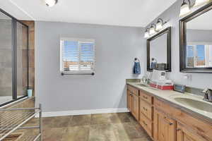 Bathroom with an enclosed shower and vanity