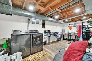 Laundry area featuring light hardwood / wood-style floors and separate washer and dryer