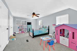 Bedroom with carpet, a closet, vaulted ceiling, and ceiling fan