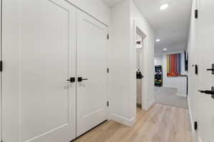 Hallway featuring light wood-type flooring