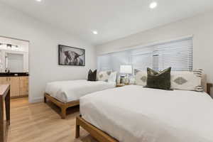 Bedroom featuring light hardwood / wood-style floors and lofted ceiling