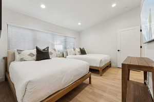 Bedroom featuring lofted ceiling and light hardwood / wood-style flooring