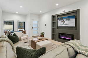 Living room featuring a large fireplace and light hardwood / wood-style floors