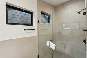 Bathroom featuring tile patterned floors and walk in shower