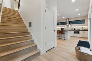 Stairs featuring wood-type flooring