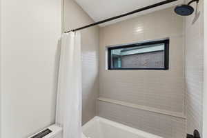 Bathroom featuring shower / bath combination with curtain