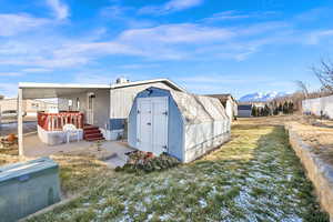 View of outdoor structure featuring a mountain view and a lawn