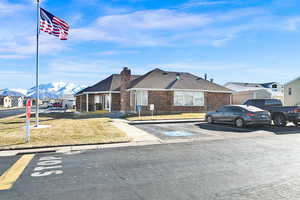 Single story home featuring a mountain view and a front yard