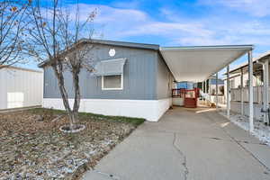 View of side of property with a carport