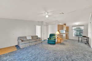 Living room featuring ceiling fan and light colored carpet