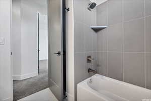 Bathroom featuring washtub / shower combination