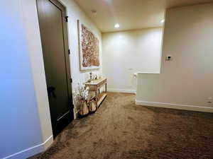 Hallway featuring carpet flooring