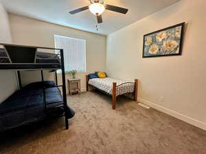 Bedroom featuring ceiling fan and carpet flooring