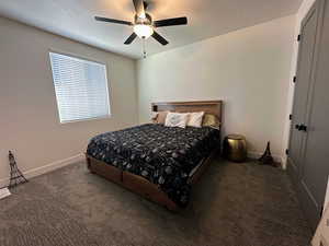 Carpeted bedroom with ceiling fan