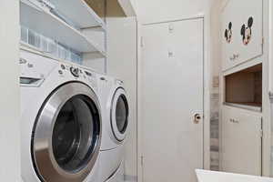 Clothes washing area featuring washer and dryer