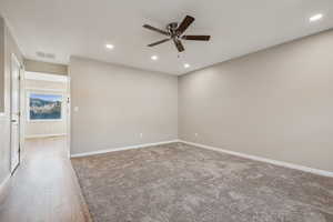 Living room with light hardwood / wood-style floors and ceiling fan