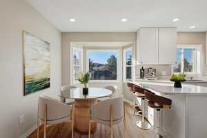 Dining area with light hardwood / wood-style floors and sink