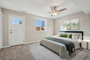 Bedroom featuring ceiling fan, light colored carpet, and multiple windows