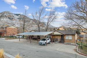 View of front of home with a mountain view and a carport