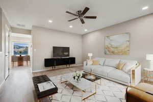 Living room featuring light hardwood / wood-style flooring and ceiling fan