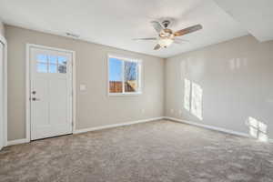 Carpeted bedroom with a closet and ceiling fan