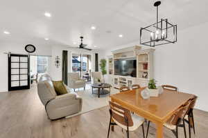 Dining room with light hardwood / wood-style floors, a textured ceiling, and ceiling fan