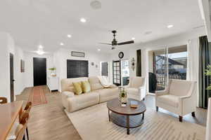 Living room featuring light wood-type flooring and a textured ceiling