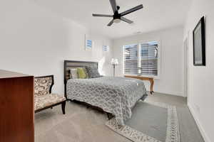 Bedroom featuring ceiling fan and light carpet