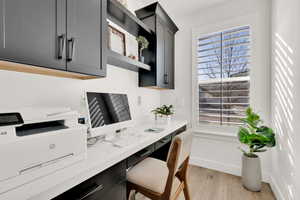 Office area with light hardwood / wood-style floors