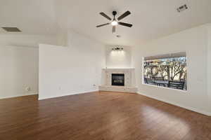 Unfurnished living room with lofted ceiling, a tiled fireplace, dark hardwood / wood-style flooring, and ceiling fan