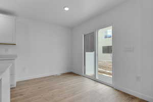 Unfurnished dining area with light wood-type flooring