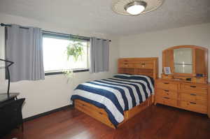 Bedroom featuring dark wood-type flooring