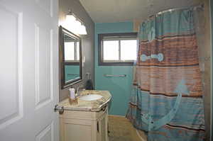 Bathroom with tile patterned floors, vanity, and walk in shower