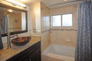 Master bathroom with vanity and shower / bath combo