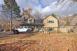 View of front facade featuring solar panels