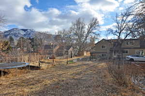 View of yard with a mountain view and a trampoline