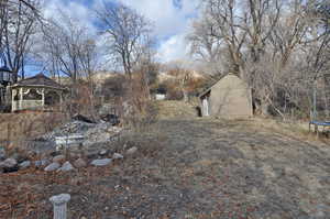 View of yard featuring a gazebo and a storage unit