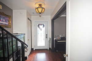 Foyer entrance with dark wood-type flooring