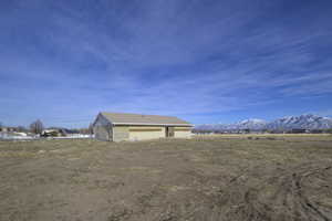 Exterior space with a garage and a mountain view