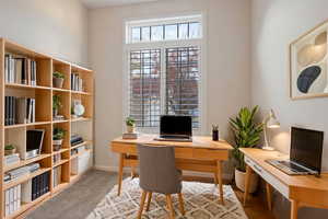 Office area featuring carpet flooring. Virtually staged.