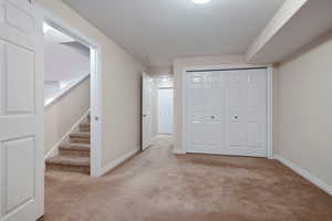 Interior space with a closet and light colored carpet