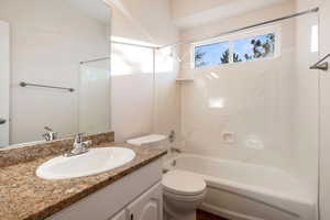 Full bathroom featuring toilet, vanity, and bathing tub / shower combination