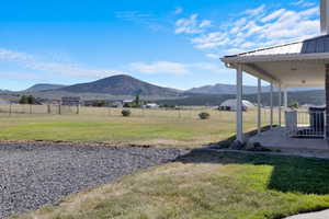 View of yard featuring a mountain view, a patio area, and a rural view