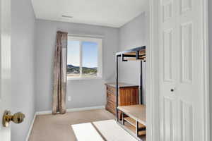 Mudroom featuring light carpet