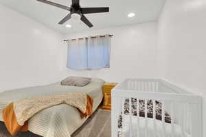 Bedroom with ceiling fan and carpet