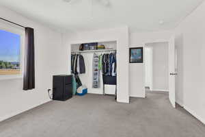 Unfurnished bedroom with light colored carpet and a closet