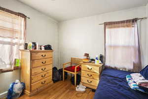 Bedroom with wood-type flooring