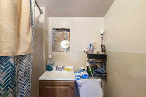 Bathroom featuring vanity, toilet, and walk in shower